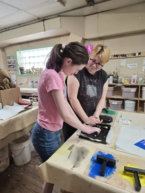 Two people working on an art project.